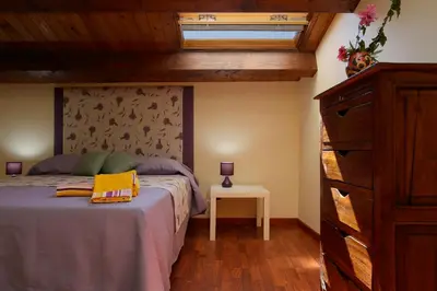 a bedroom with a bed and a dresser and a window at Casa Matrangela in Palermo