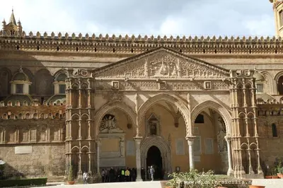 a large building with an archway and a clock tower at Casa Matrangela in Palermo