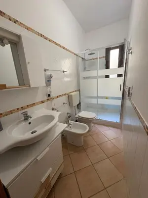 a bathroom with a sink and a toilet at Tonnara Apartments in Alcamo Marina