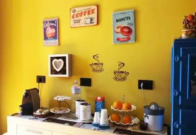 a yellow wall with a counter with oranges on it at L'Aquilone B&B in Palermo