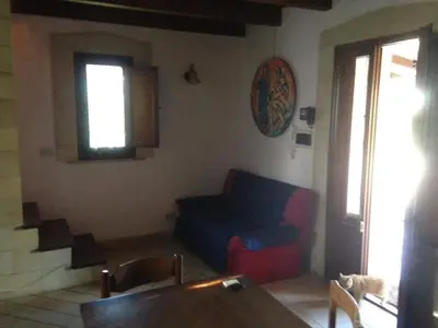 a living room with a couch and a window at Le 3 tartarughe in Lascari
