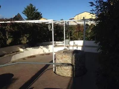 a suitcase sitting under a cover on a sidewalk at Le 3 tartarughe in Lascari