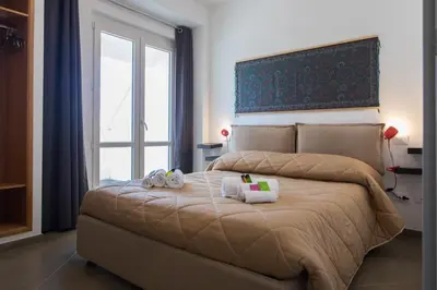 a bedroom with a large bed with towels on it at Overseas - Penthouse with terrace - Attico - Palazzo San Matteo in Palermo