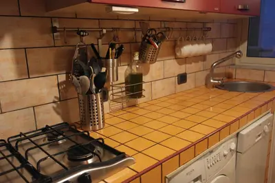 a kitchen counter with a stove and a sink at CasaLù in Palermo
