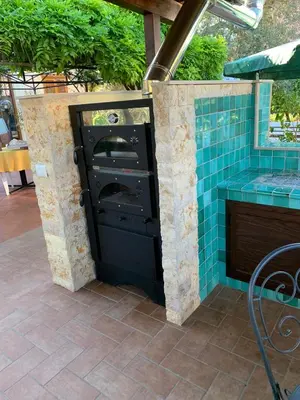 a kitchen with a black door with blue tiles at Green Garden 2017 in Mondello