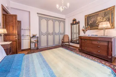 a bedroom with a bed and a dresser and a mirror at Green Garden 2017 in Mondello