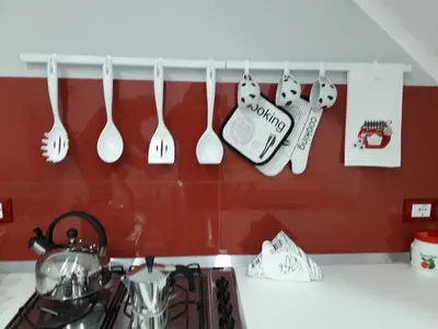 a kitchen with utensils hanging on a wall at Casa Tiziana in Castellammare del Golfo