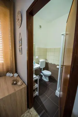 a bathroom with a toilet and a tub and a sink at Alle Vigne Affittacamere in Alcamo