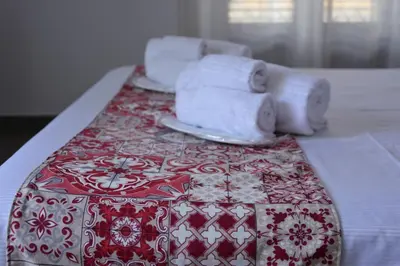 a table with towels and towels on top of a bed at B&B Le Porte Del Centro in Palermo