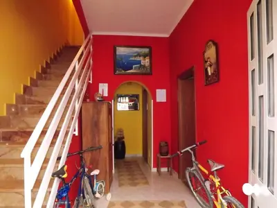 two bikes parked in a room with red walls at B&B Il Girasole in Balestrate