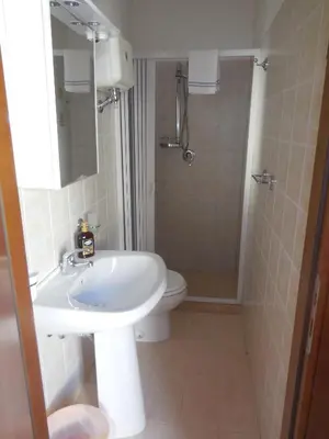 a bathroom with a sink and a toilet and a shower at New Eden in San Vito lo Capo