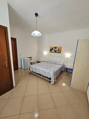 a bedroom with a bed in the middle of a room at New Eden in San Vito lo Capo