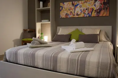 a bedroom with a large bed with towels on it at Casa Gaia Palermo in Palermo