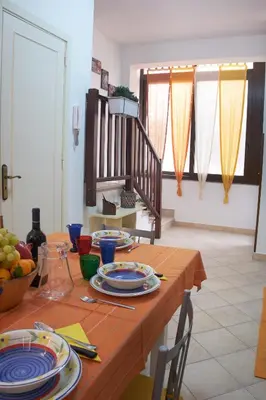 a dining room table with plates and dishes on it at Casa Gaia Palermo in Palermo