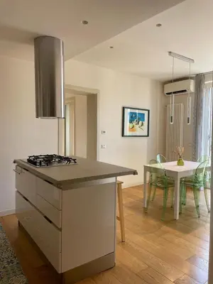 a kitchen and dining room with a stove and a table at Le Stanze di Federico apartment e Costanza Luxury apartment in Palermo