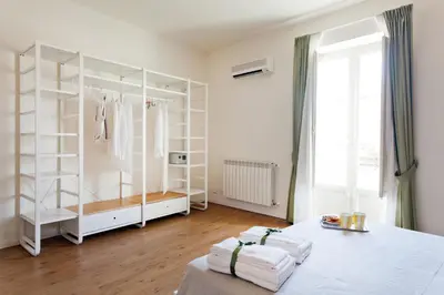 a room with a white closet with white shelves at Le Stanze di Federico apartment e Costanza Luxury apartment in Palermo