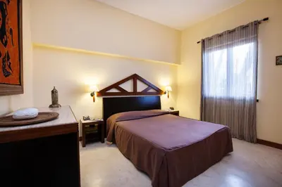 a hotel room with a bed and a window at Villa Sole in San Vito lo Capo