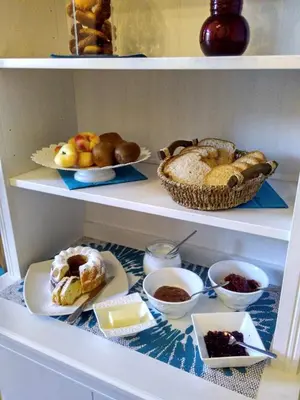 a shelf filled with different types of bread and pastries at il lapino in Palermo