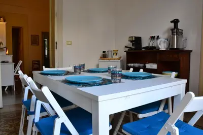 a white table with blue plates on top of it at il lapino in Palermo