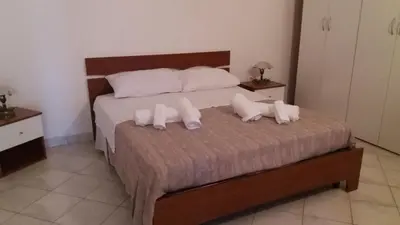 a bedroom with a bed with two pillows on it at Casa Timpanella in Partinico