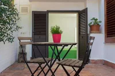 a table and chairs on a patio with a plant at Piccola Oasi in Mondello