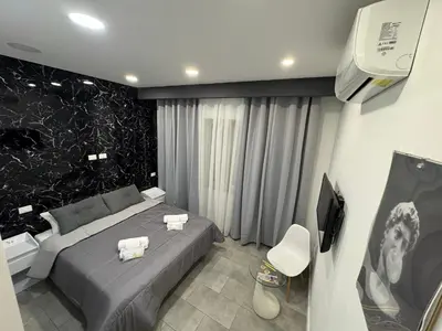 a bedroom with a bed and a tv in it at Ri.Mo's Rent Room in Palermo