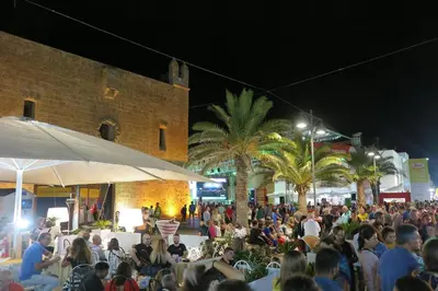 a large crowd of people sitting at tables at night at holiday home LG in San Vito lo Capo
