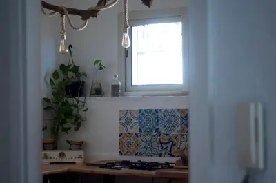 a kitchen with a window and a stove top oven at Addumari in Palermo
