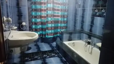 a bathroom with a sink and a bath tub at Appartamento Vacanza Luna in Partinico