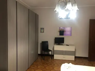 a bedroom with a bed and a desk with a computer at Appartamento Vacanza Luna in Partinico
