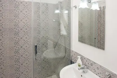 a bathroom with a shower and a sink at White in Castellammare del Golfo