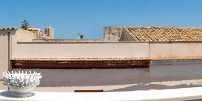 a white vase sitting on top of a building at Il Mare Dentro Rooms in San Vito lo Capo