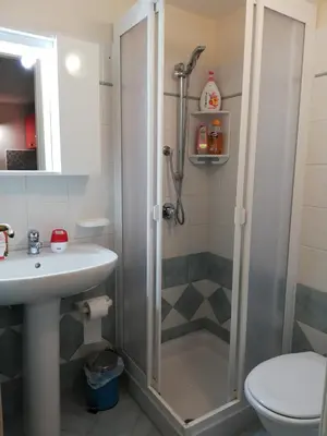 a bathroom with a shower and a sink and a toilet at Appartamenti La Stella in Castellammare del Golfo