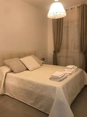 a bedroom with a bed with towels on it at Holiday & House - Imparato Vacanze Prestige Mondello in Mondello