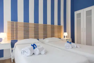 a bedroom with two beds with towels on them at Zammù in Palermo