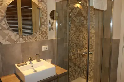 a bathroom with a sink and a shower at Zammù in Palermo