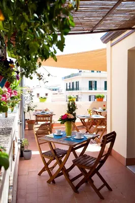 a patio with a table and chairs on a balcony at Quattro Incanti in Palermo