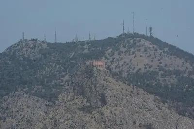 a mountain with a building on top of it at B&B Attico 33 in Palermo