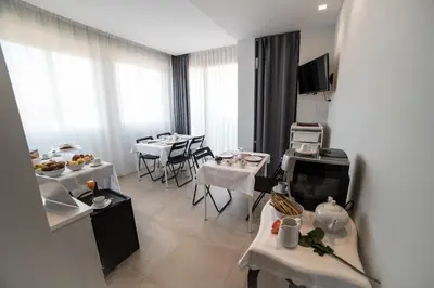 a dining room with tables and white tables and chairs at B&B Attico 33 in Palermo