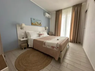 a bedroom with a bed and a large window at Cima Bianca in San Vito lo Capo