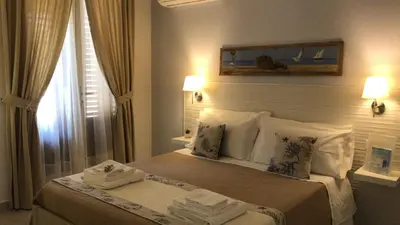 a bedroom with a bed with two towels on it at Cima Bianca in San Vito lo Capo