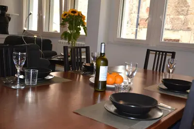 a bottle of wine sitting on a wooden table at Luci della città Palazzo San Matteo in Palermo