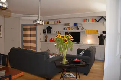 a living room with a couch and a table with a vase of flowers at Luci della città Palazzo San Matteo in Palermo