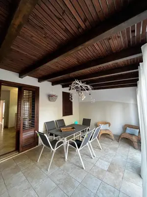 a dining room with a table and chairs at Sicilia Vacation in San Vito lo Capo