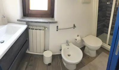 a bathroom with a toilet and a tub and a sink at A un passo dal mare in Lido di Mondello