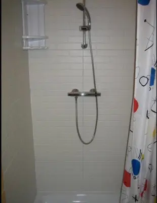 a shower with a shower head in a bathroom at Case Vacanza Cipriano spacious apartment and cosy studio monolocale in Torretta