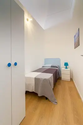 a bedroom with a bed in a white room at Casa Turano in Castellammare del Golfo