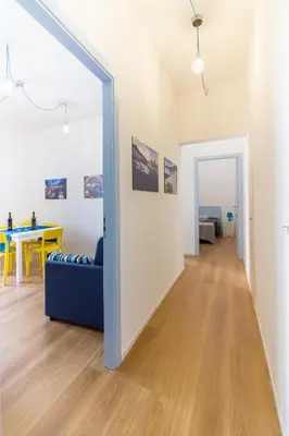 a living room with a blue couch and a table at Casa Turano in Castellammare del Golfo