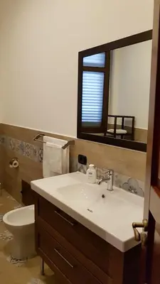 a bathroom with a sink and a toilet and a mirror at b&b Caravella in Mezzojuso