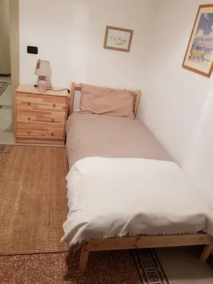 a bedroom with two twin beds and a dresser at Duchi in Palermo
